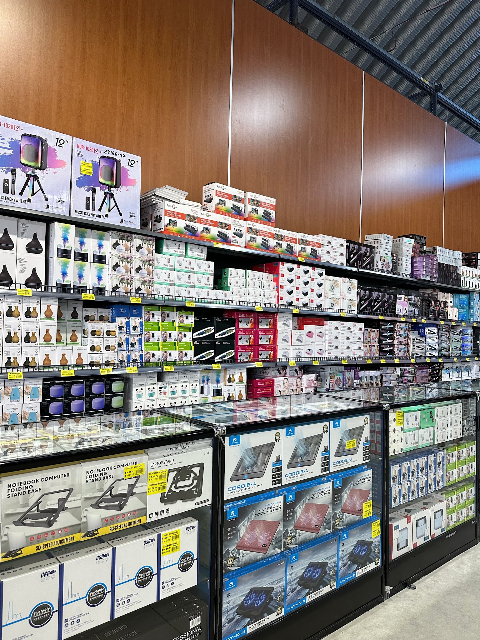 A stocked retail display of home and everyday products viewed from the aisle